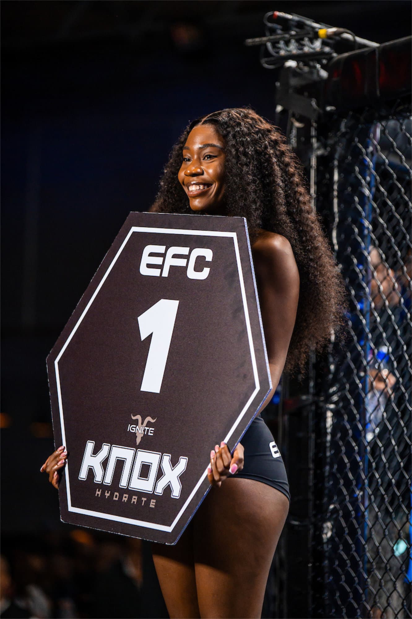 EFC ring girl holding round card in the octagon