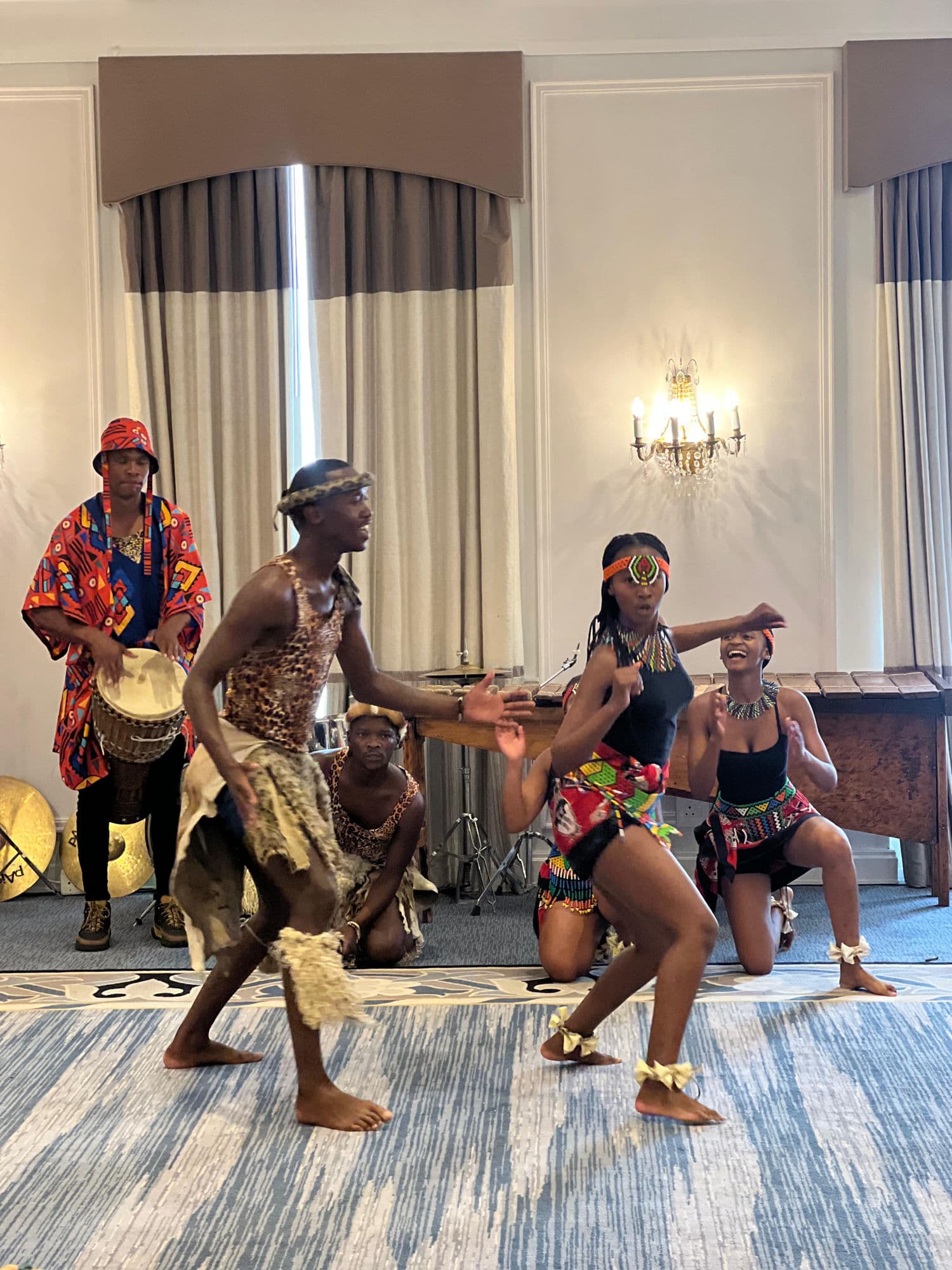 Traditional African dancers mid-performance at a corporate event