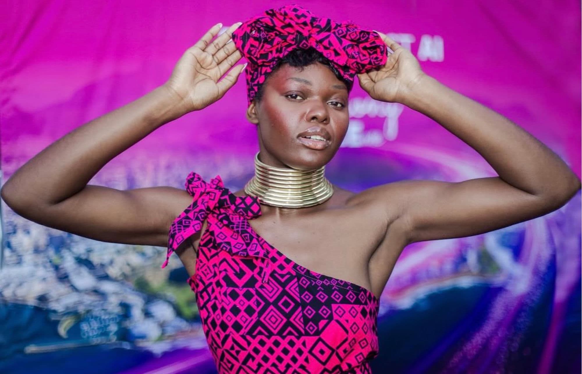 Performer in pink headwrap at an entertainment event
